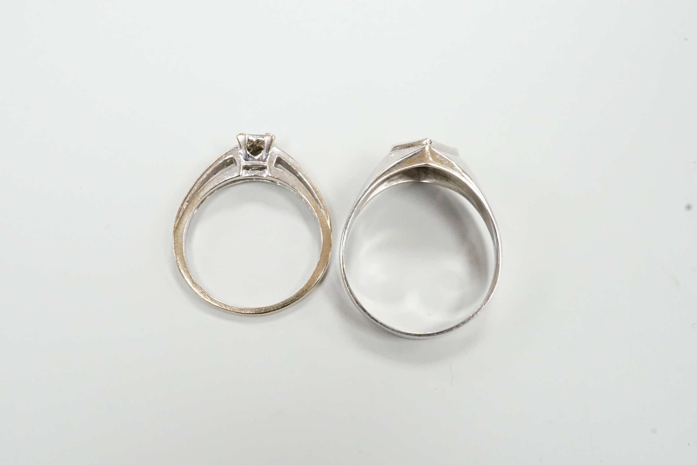 A 585 white metal and solitaire diamond ring, size U/V, gross weight 3.5 grams and a modern 18ct white gold and four stone diamond cluster set ring, size P/Q, gross weight 3.4 grams.